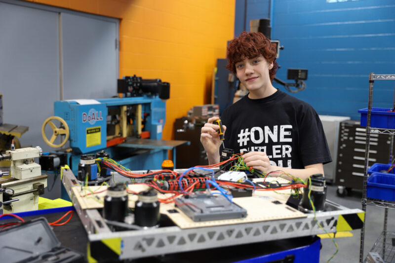 A young person with curly hair, wearing a 