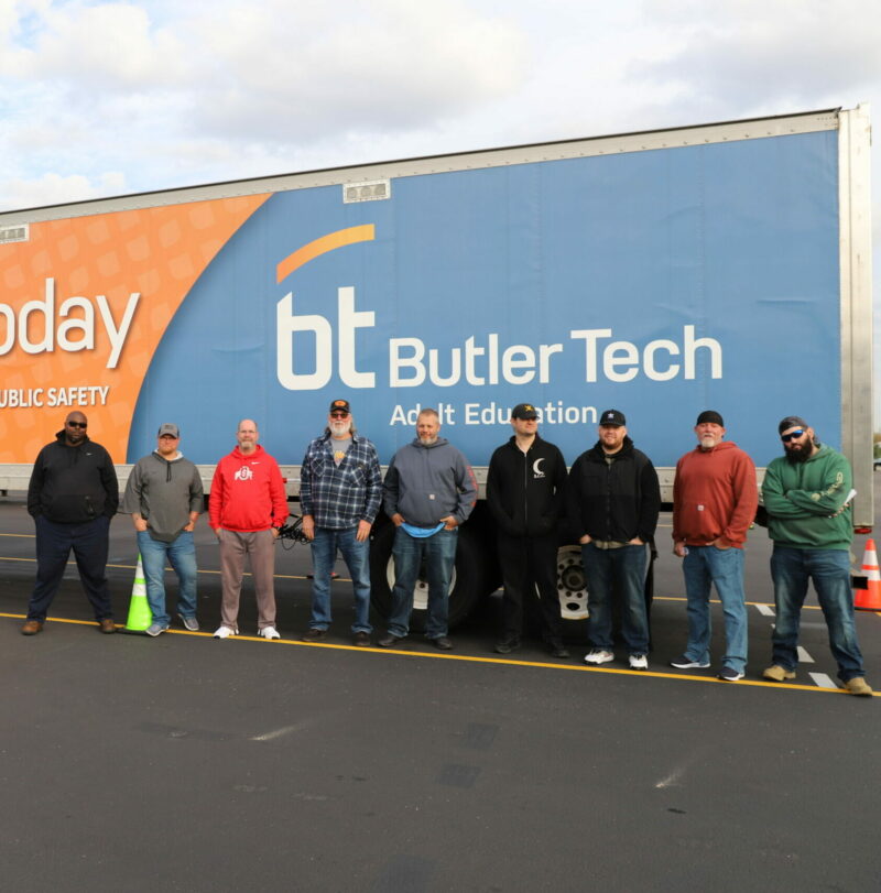 men standing in front of a Butler Tech CDL truck