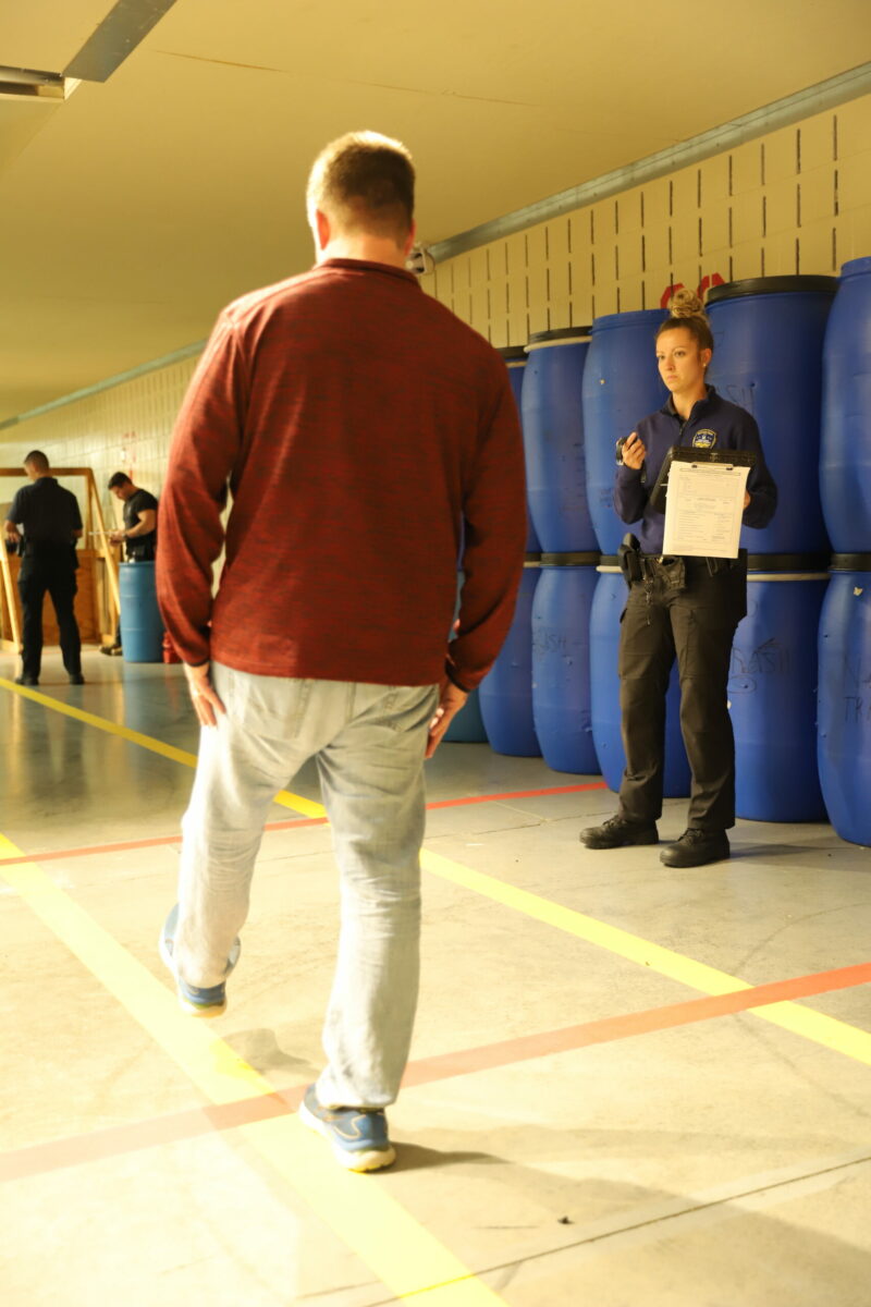 Basic Police Academy cadet administering sobriety testing in a simulation at Butler Tech