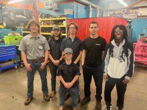 group of students in a garage 