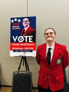 A smiling person in a red blazer stands next to a campaign poster for the 2025 Regional Elections, which reads "Vote Chase McDonald for Regional Officer" and features their photo along with the SkillsUSA and BT logos.