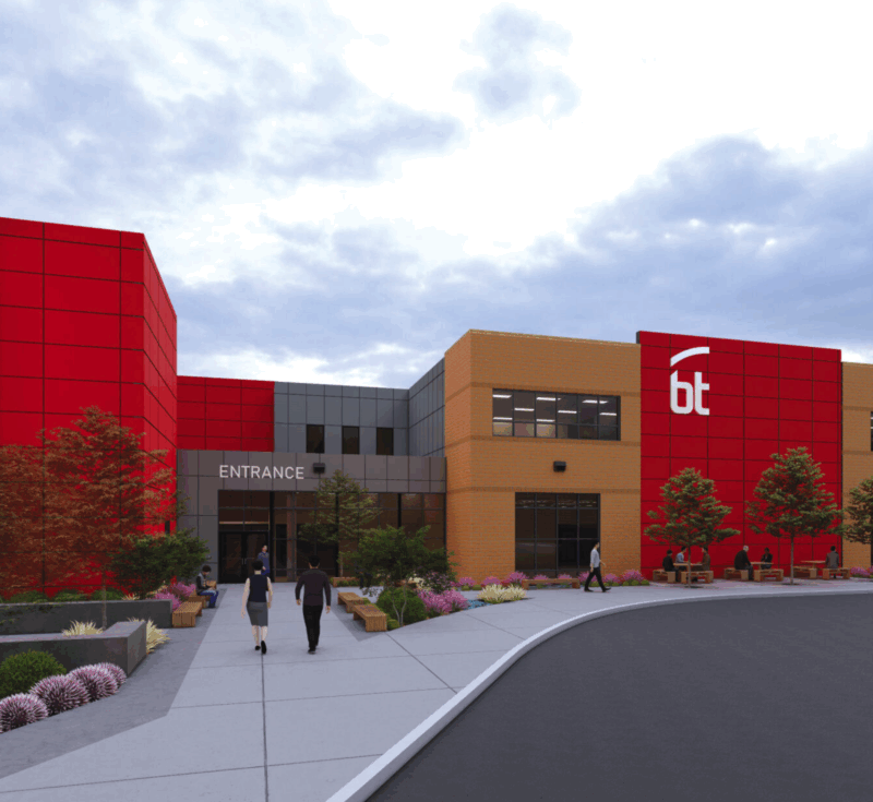 A modern Bioscience Center with red and tan sections, large windows, and a 