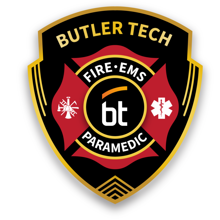 A black and gold shield badge with "Butler Tech" at the top, a red Maltese cross, and the words "Fire • EMS • Paramedic." The center features "bt," icons for firefighting and medical services, and celebrates Adult Education Fire & EMT Commencement.